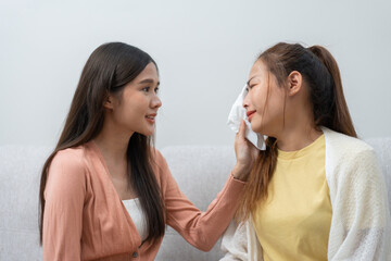 Two women talking about problems at home. Asian women embrace to calm their sad best friends from feeling down. Female friends supporting each other. Problems, friendship, and care concept