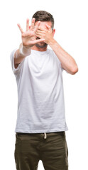 Young handsome man over isolated background covering eyes with hands and doing stop gesture with sad and fear expression. Embarrassed and negative concept.