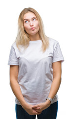 Young caucasian woman over isolated background making fish face with lips, crazy and comical gesture. Funny expression.