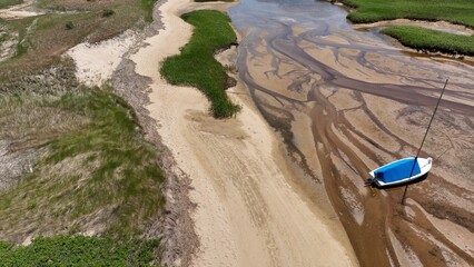 Looking down on marsh inlet at low tide at Cape Cod National Seashore, a family vacation destination by the Atlantic ocean in state of MASS in America