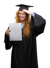 Young redhead woman wearing graduate uniform holding degree stressed with hand on head, shocked with shame and surprise face, angry and frustrated. Fear and upset for mistake.