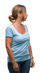 Middle age senior hispanic woman over isolated background looking to side, relax profile pose with...