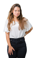 Obraz premium Young beautiful brunette business woman over isolated background puffing cheeks with funny face. Mouth inflated with air, crazy expression.