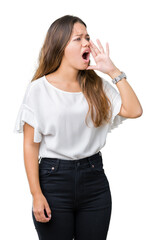 Young beautiful brunette business woman over isolated background shouting and screaming loud to side with hand on mouth. Communication concept.