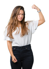 Obraz premium Young beautiful brunette business woman over isolated background Strong person showing arm muscle, confident and proud of power