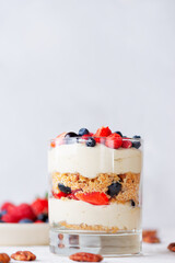 Sweet dessert in a glass with berries, whipped cream and biscuit. Healthy food, vegan, sugar, gluten and lactose free.