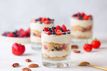 Dessert in a glasses with berries, whipped cream and biscuit. Healthy food, vegan, sugar, gluten...