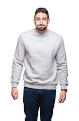 Fototapeta premium Young handsome man wearing sweatshirt over isolated background puffing cheeks with funny face. Mouth inflated with air, crazy expression.