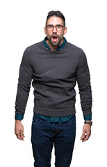 Fototapeta premium Young handsome man wearing glasses over isolated background afraid and shocked with surprise expression, fear and excited face.