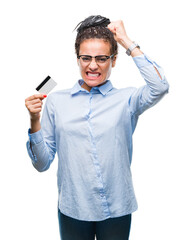 Young african american girl holding credit card over isolated background annoyed and frustrated shouting with anger, crazy and yelling with raised hand, anger concept