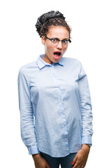 Young braided hair african american business girl wearing glasses over isolated background afraid and shocked with surprise expression, fear and excited face.