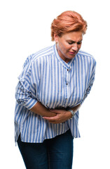 Fototapeta premium Atrractive senior caucasian redhead woman over isolated background with hand on stomach because nausea, painful disease feeling unwell. Ache concept.