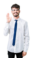Young handsome business man wearing glasses over isolated background Waiving saying hello happy and smiling, friendly welcome gesture
