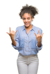 Young afro american woman over isolated background shouting with crazy expression doing rock symbol with hands up. Music star. Heavy concept.