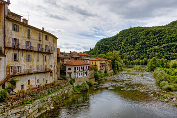 The Sesia River flows through the old town of the Alpine village of Varallo - obrazy, fototapety, plakaty