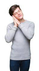 Young handsome man wearing winter sweater over isolated background sleeping tired dreaming and posing with hands together while smiling with closed eyes.