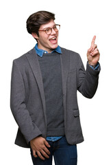 Young handsome business man wearing glasses over isolated background with a big smile on face, pointing with hand and finger to the side looking at the camera.