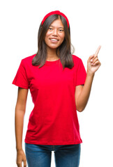 Fototapeta na wymiar Young asian woman over isolated background with a big smile on face, pointing with hand and finger to the side looking at the camera.