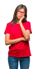 Young asian woman wearing glasses over isolated background thinking looking tired and bored with depression problems with crossed arms.