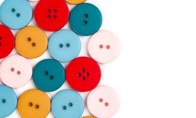 White background with different plastic round multicolored buttons