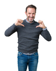 Handsome middle age senior man wearing a sweater over isolated background looking confident with...