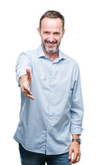 Middle age hoary senior business man over isolated background smiling friendly offering handshake as greeting and welcoming. Successful business.
