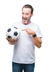 Middle age hoary senior man holding soccer football ball over isolated background very happy pointing with hand and finger