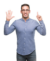 Fototapeta premium Handsome young elegant man wearing glasses showing and pointing up with fingers number six while smiling confident and happy.