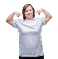 Young adult woman with down syndrome over isolated background smiling confident showing and pointing with fingers teeth and mouth. Health concept.