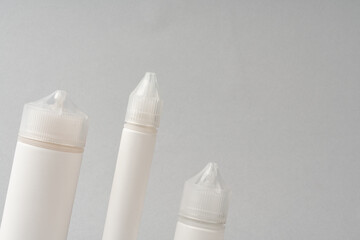 Refill liquid for electronic cigarettes on gray background