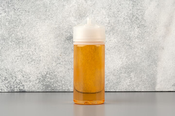Refill liquid for electronic cigarettes on gray background