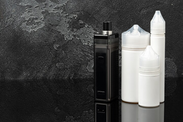 Electronic cigarette with re-fill liquid bottles on gray background