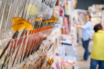 Selective focus on group of paintbrushes displayed for sale in creative art shop. Fine art....