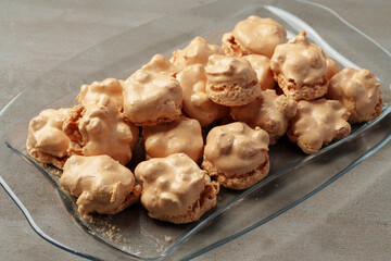 Crunchy homemade cookies on glass plate on gray background