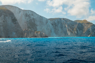 Beautiful turquoise blue Ionian sea with boat near Navagio bay, famous popular place on Zakynthos island