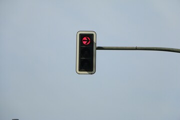 red right turn traffic light hanging on metal post