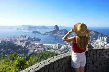 Holidays in Rio de Janeiro. Rear view of tourist woman enjoying sight of famous Guanabara Bay with...