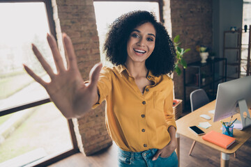 Portrait of cheerful friendly company representative beaming smile arm palm give you high five waving hi workplace indoors