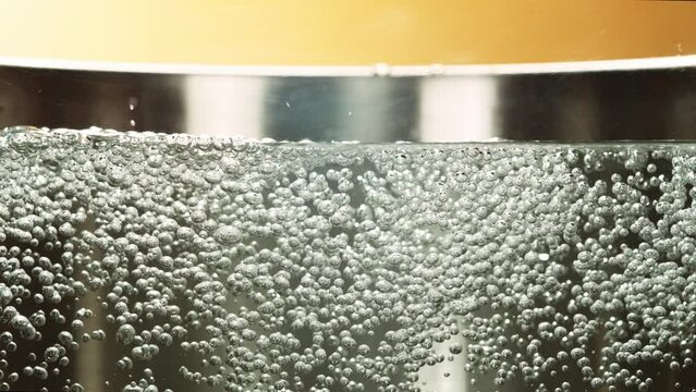 Super Slow Motion of Bubbling Boiling Water in Pot. Filmed on High Speed Cinema Camera, 1000 fps.