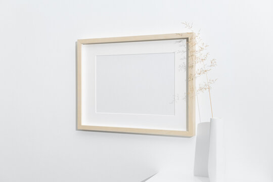Wooden landscape frame mockup on white wall with copy space for artwork design