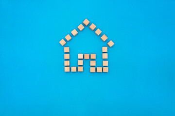 ドア付の家マークのウッドキューブの青い背景の正面