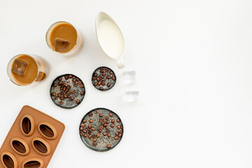 Two glasses of cold drew coffee drink with ice with coffee beans