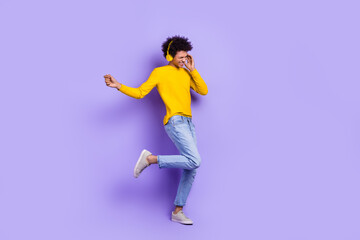 Fototapeta na wymiar Full body length size photo of energetic dance positive guy careless chill have fun wireless headphones isolated on violet color background