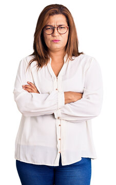 Middle age latin woman wearing casual clothes and glasses skeptic and nervous, disapproving expression on face with crossed arms. negative person.