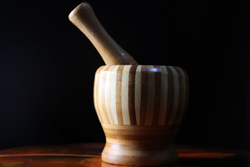 Pilon for crushing garlic with intermediate light on a dark background