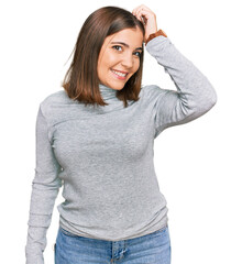 Fototapeta premium Young beautiful woman wearing casual turtleneck sweater smiling confident touching hair with hand up gesture, posing attractive and fashionable