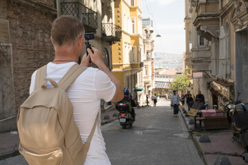 A male tourist filming a spot next to the Galata Tower in Istanbul, Turkey. Blogger activity