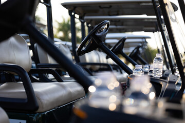 Water bottle in golf carts for golf player on golf course. golf course carts cars at luxury golf...