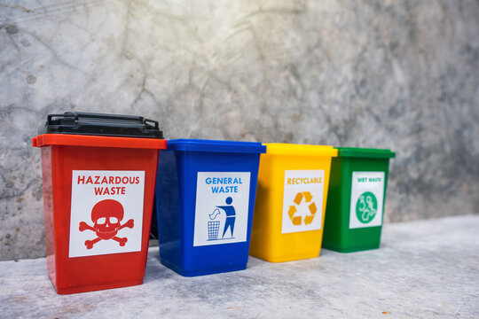 The concept of waste classification for recycling. Collection of bins for different types of garbage by separation according to the color of the bin with old wall background.