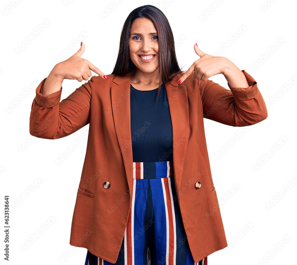 Wall mural Young beautiful brunette woman wearing elegant clothes looking confident with smile on face, pointing oneself with fingers proud and happy.